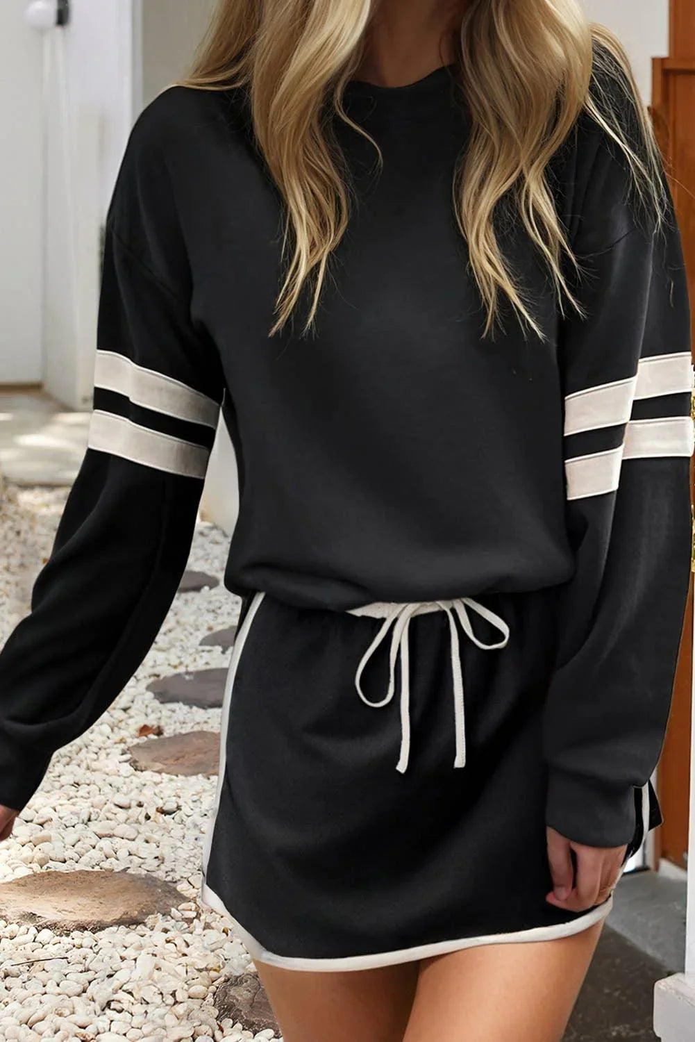 Black long sleeve sweatshirt with white stripe sleeves and matching drawstring shorts, casual athleisure outfit