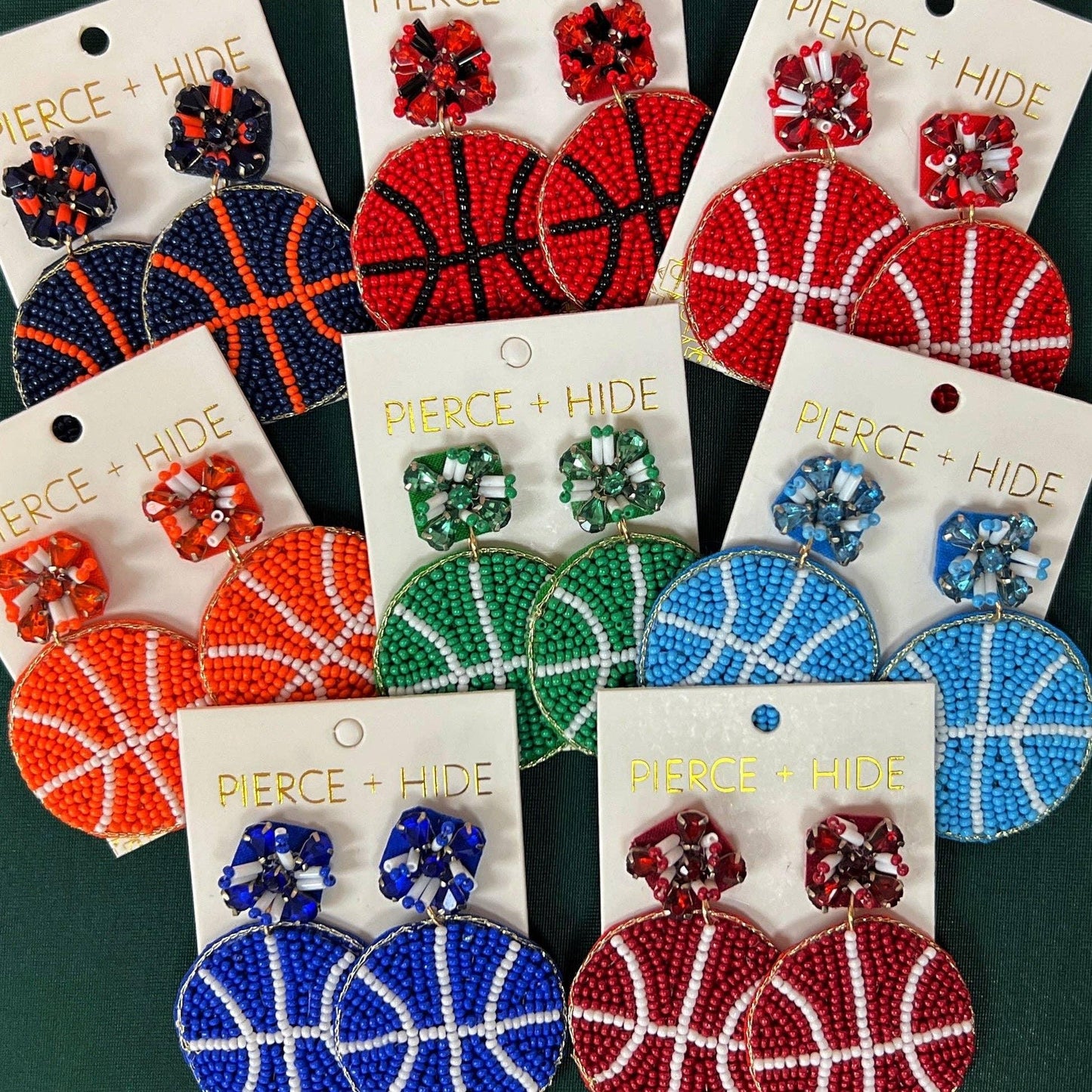 Colorful beaded basketball earrings in red, blue, green, and orange with floral accents