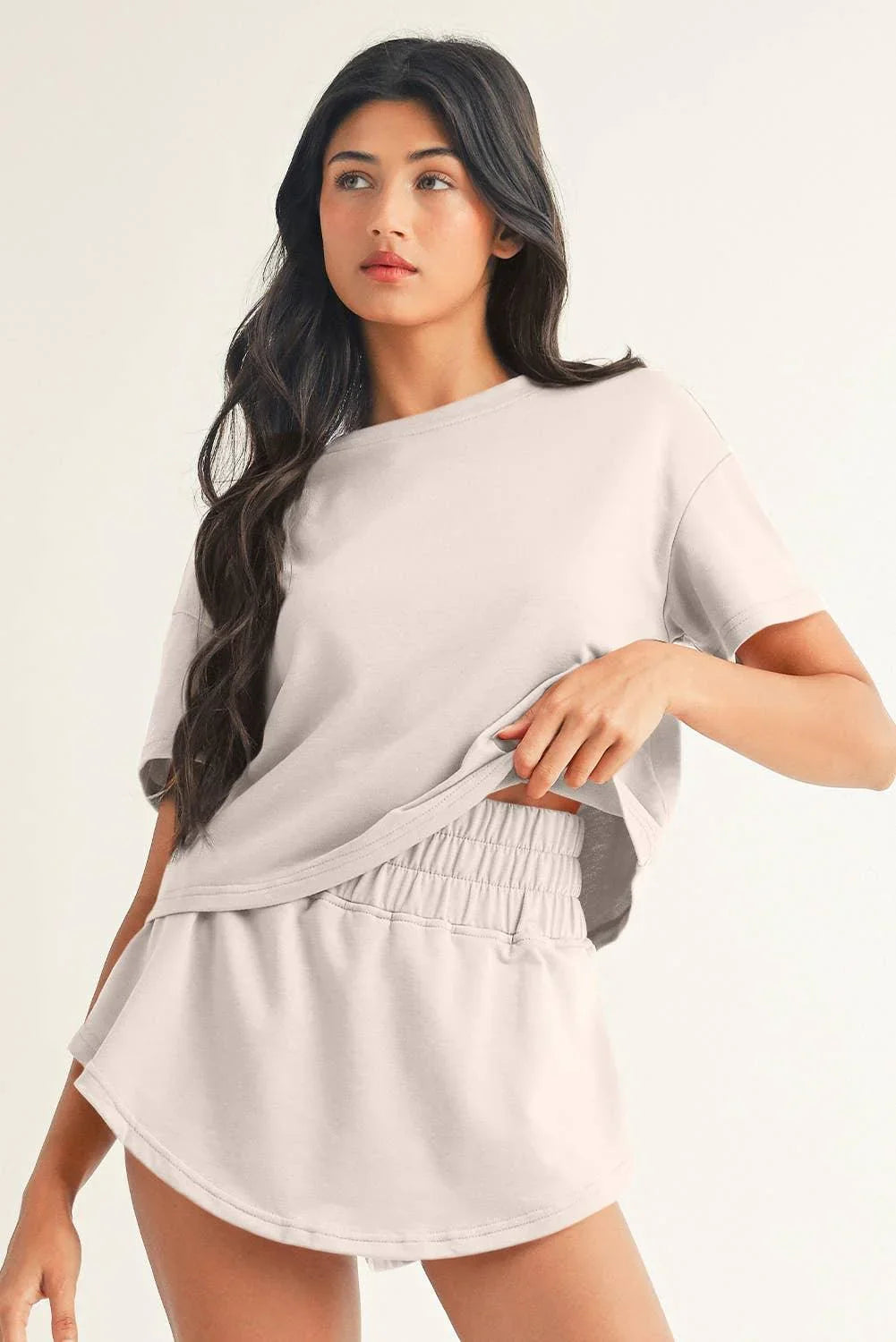 Woman modeling soft gray oversized crop top and matching shorts set, casual loungewear outfit