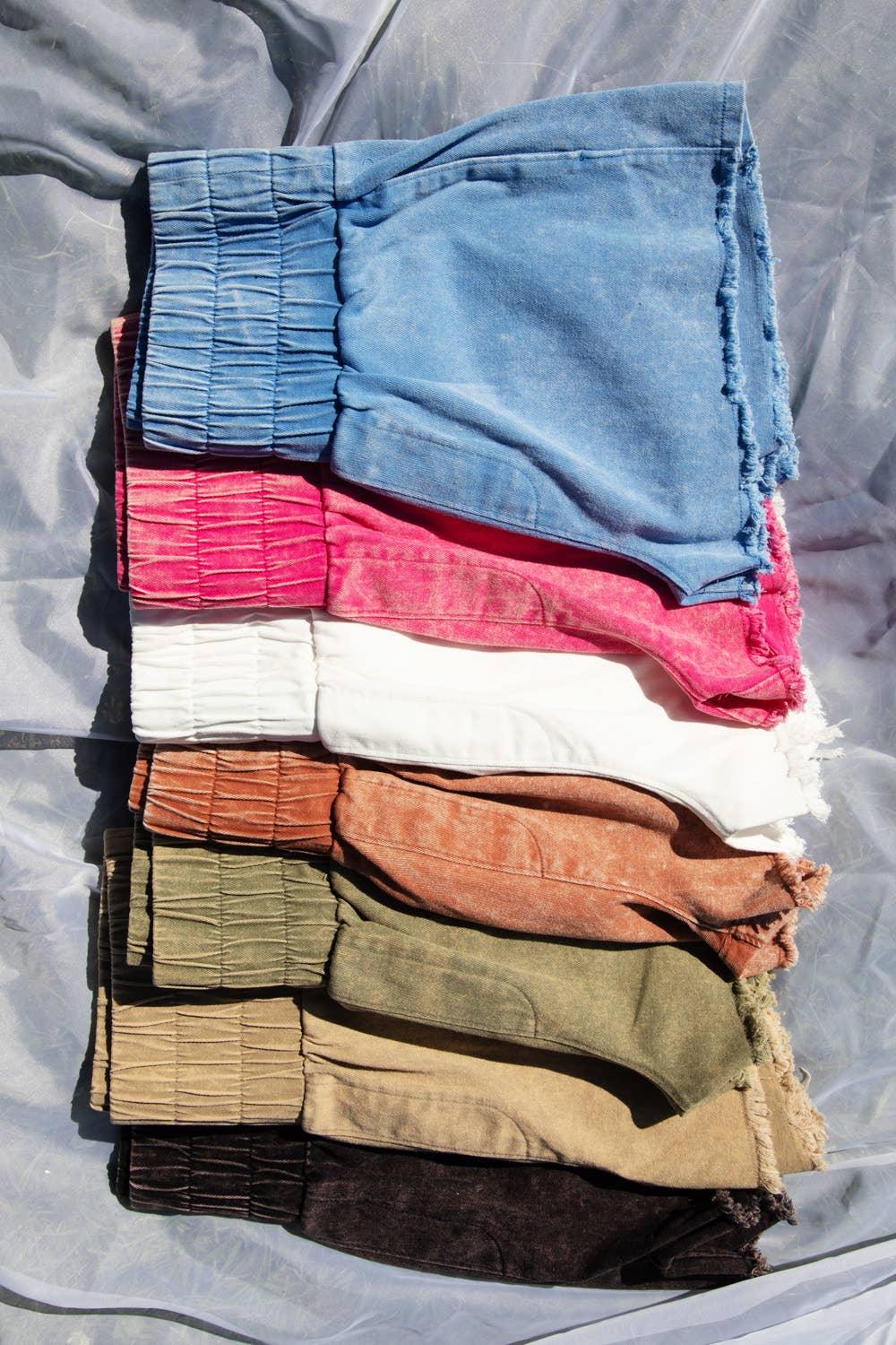 Stacked colorful denim shorts with frayed hems and elastic waistbands for casual fashion