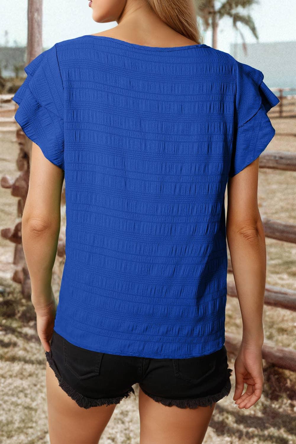 Blue ruffled sleeve top with textured back, paired with black denim shorts for casual summer style