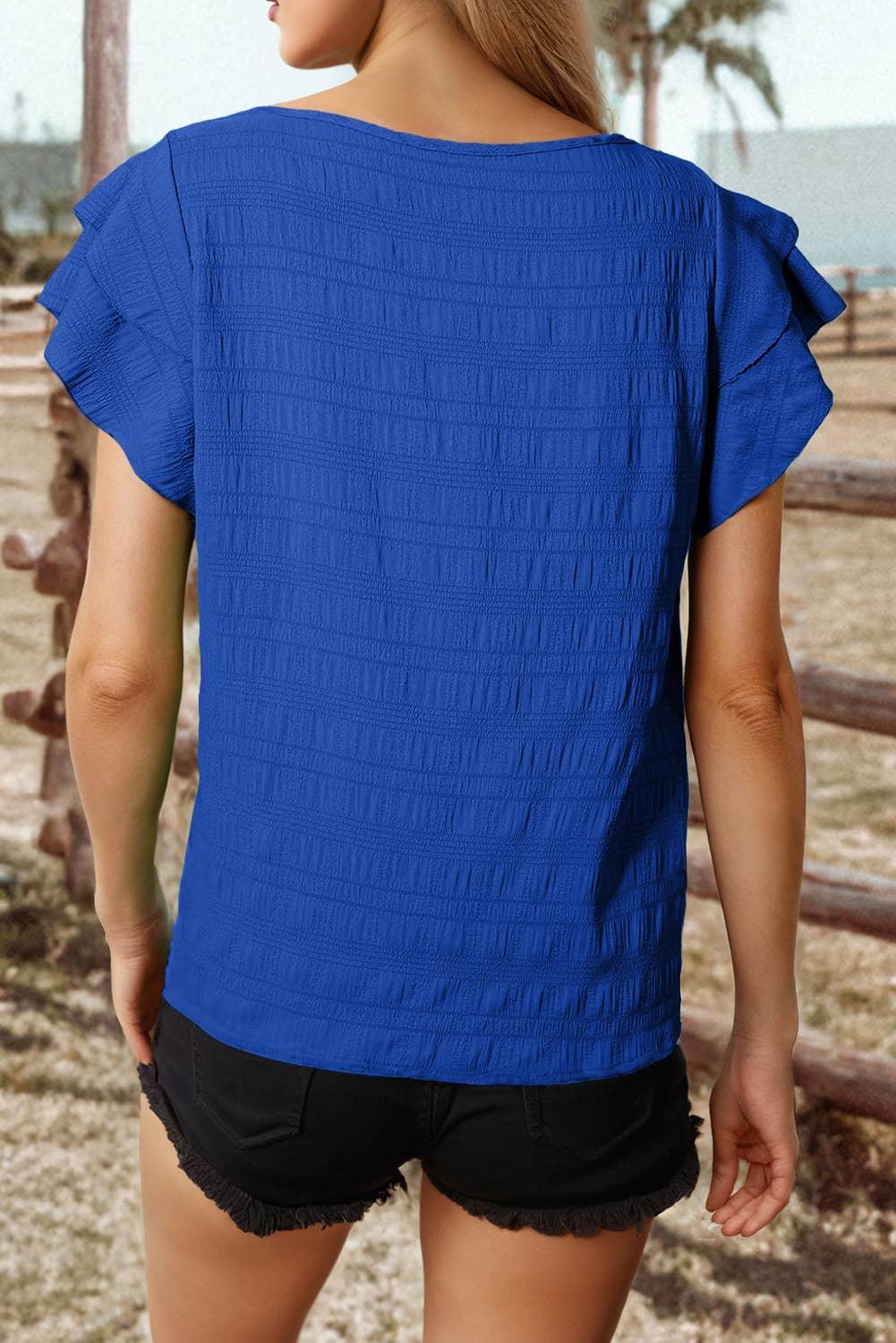 Blue ruffled sleeve top with textured back, paired with black denim shorts for casual summer style