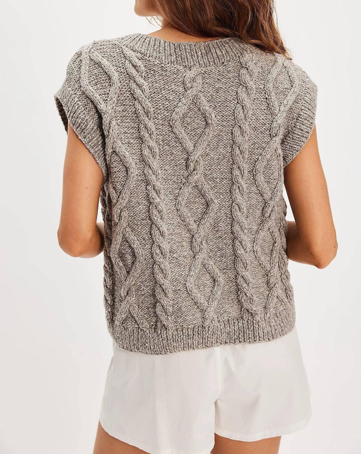 Gray cable knit sweater with short sleeves, back view, paired with white shorts for casual style