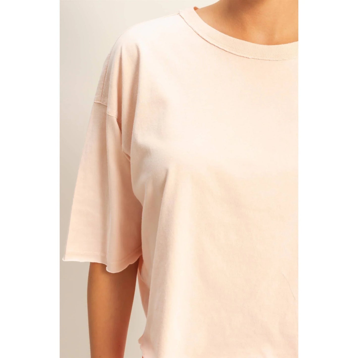 Soft blush oversized t-shirt with relaxed fit and crew neckline, ideal for casual fashion