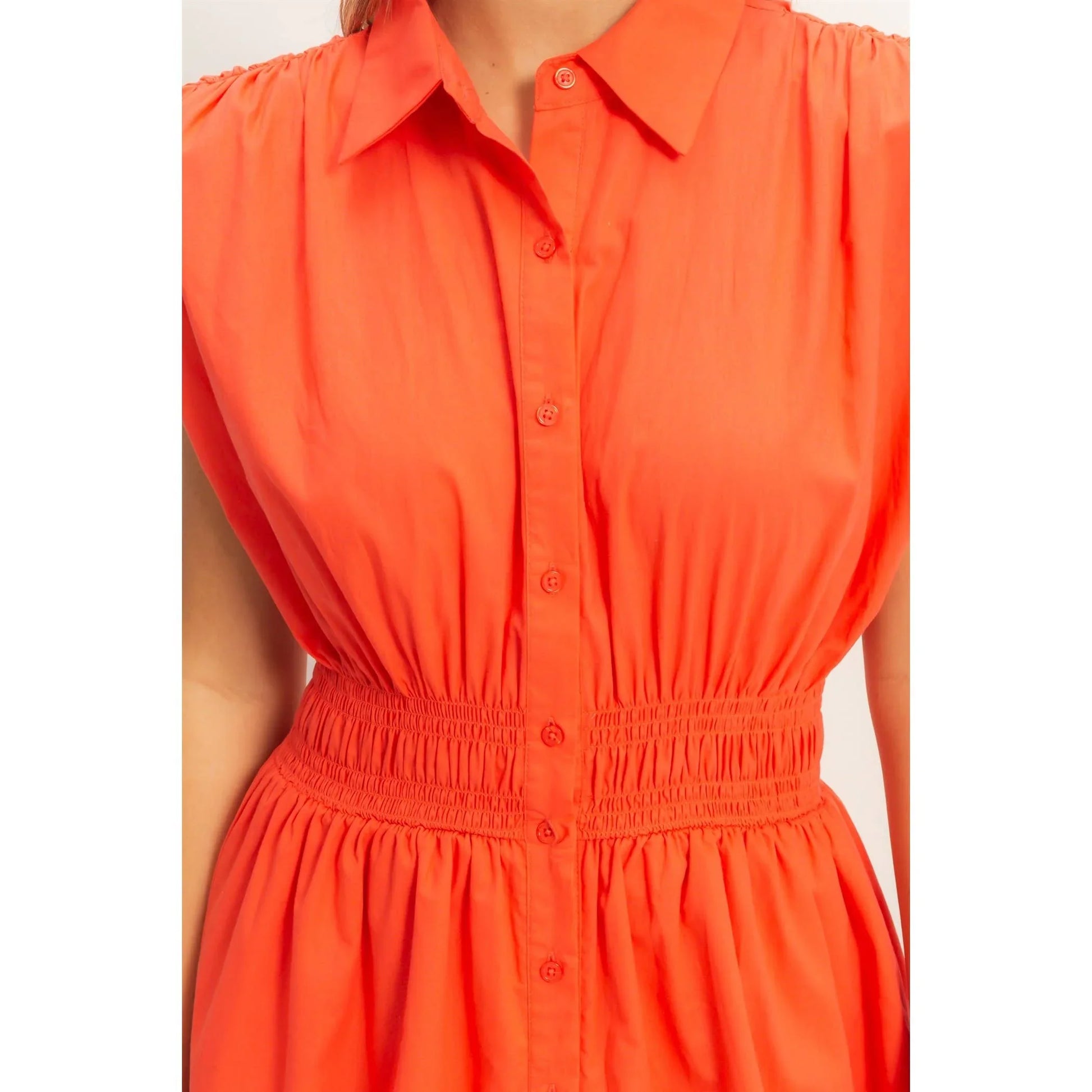 Vibrant orange button-down dress with smocked waist and puff sleeves