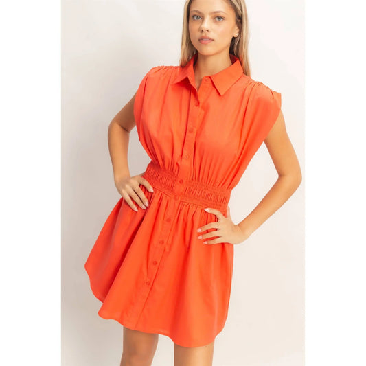 Vibrant orange button-down shirt dress with smocked waist and puff sleeves, perfect for summer fashion.