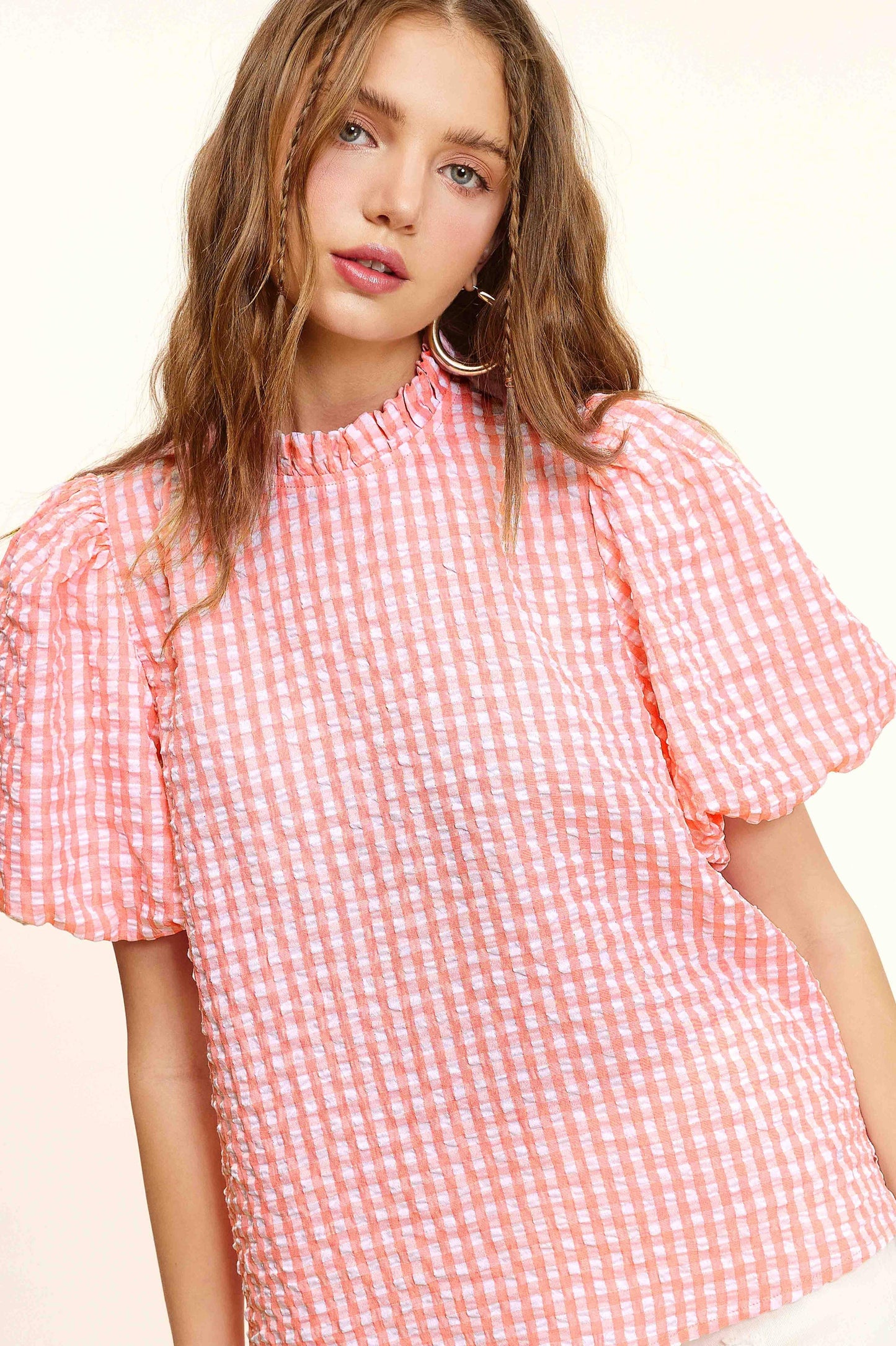 Woman in pink and white gingham puff sleeve blouse, Lou's Boutique fashion