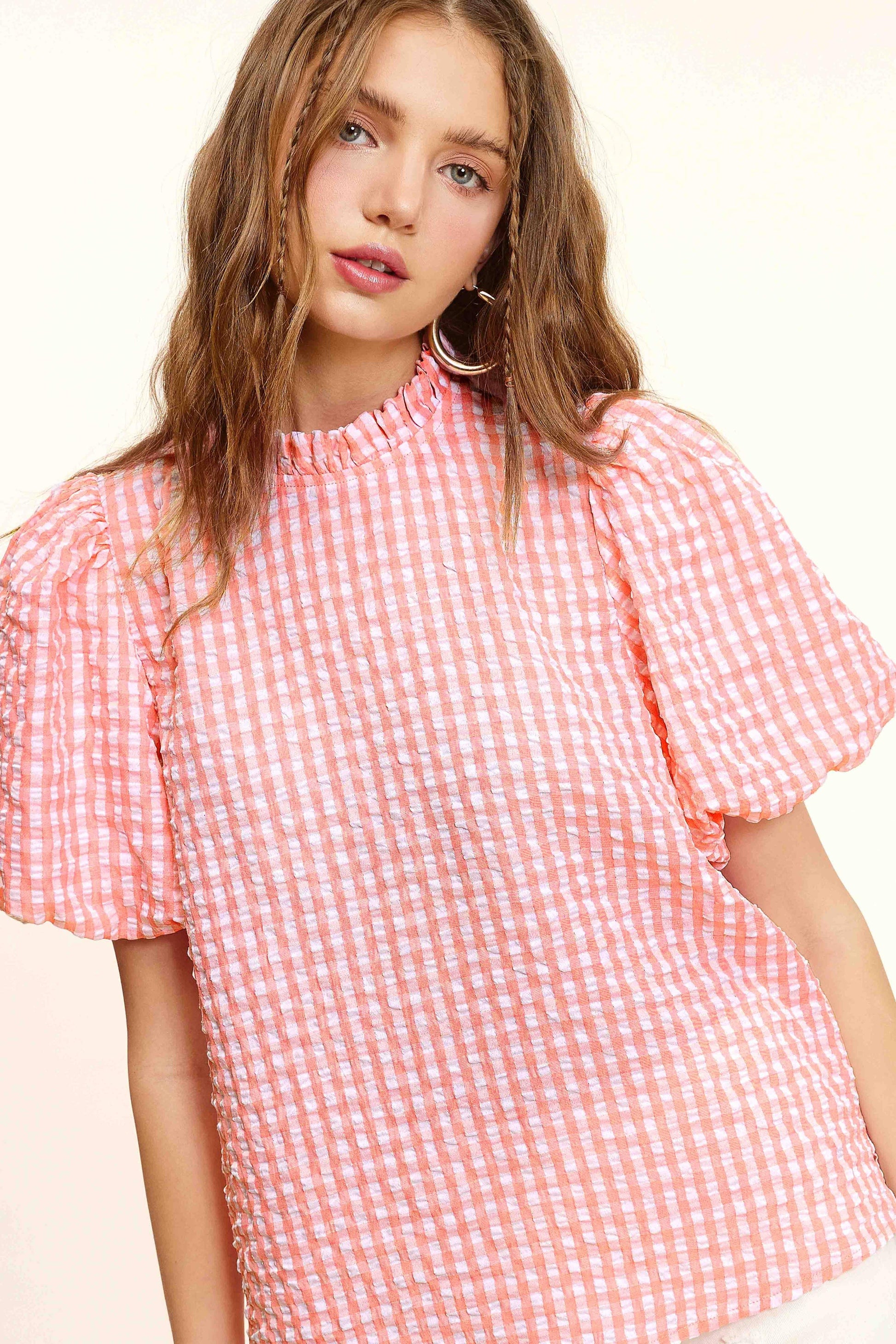 Woman in pink and white gingham puff sleeve blouse, Lou's Boutique fashion