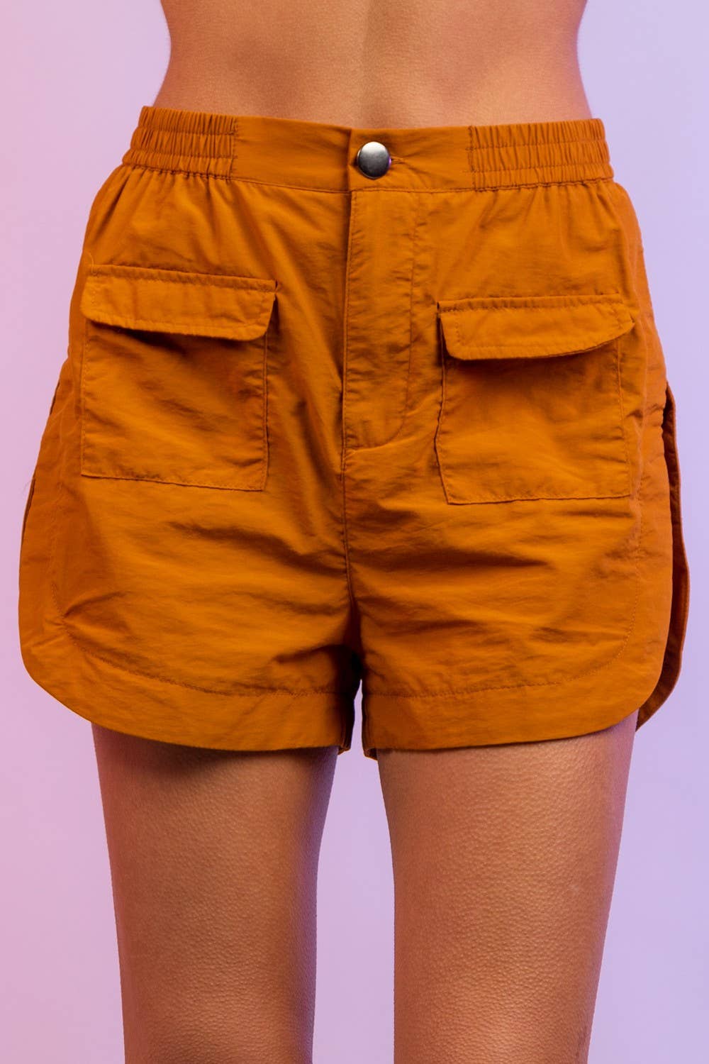 High-waisted orange shorts with front flap pockets, casual summer fashion
