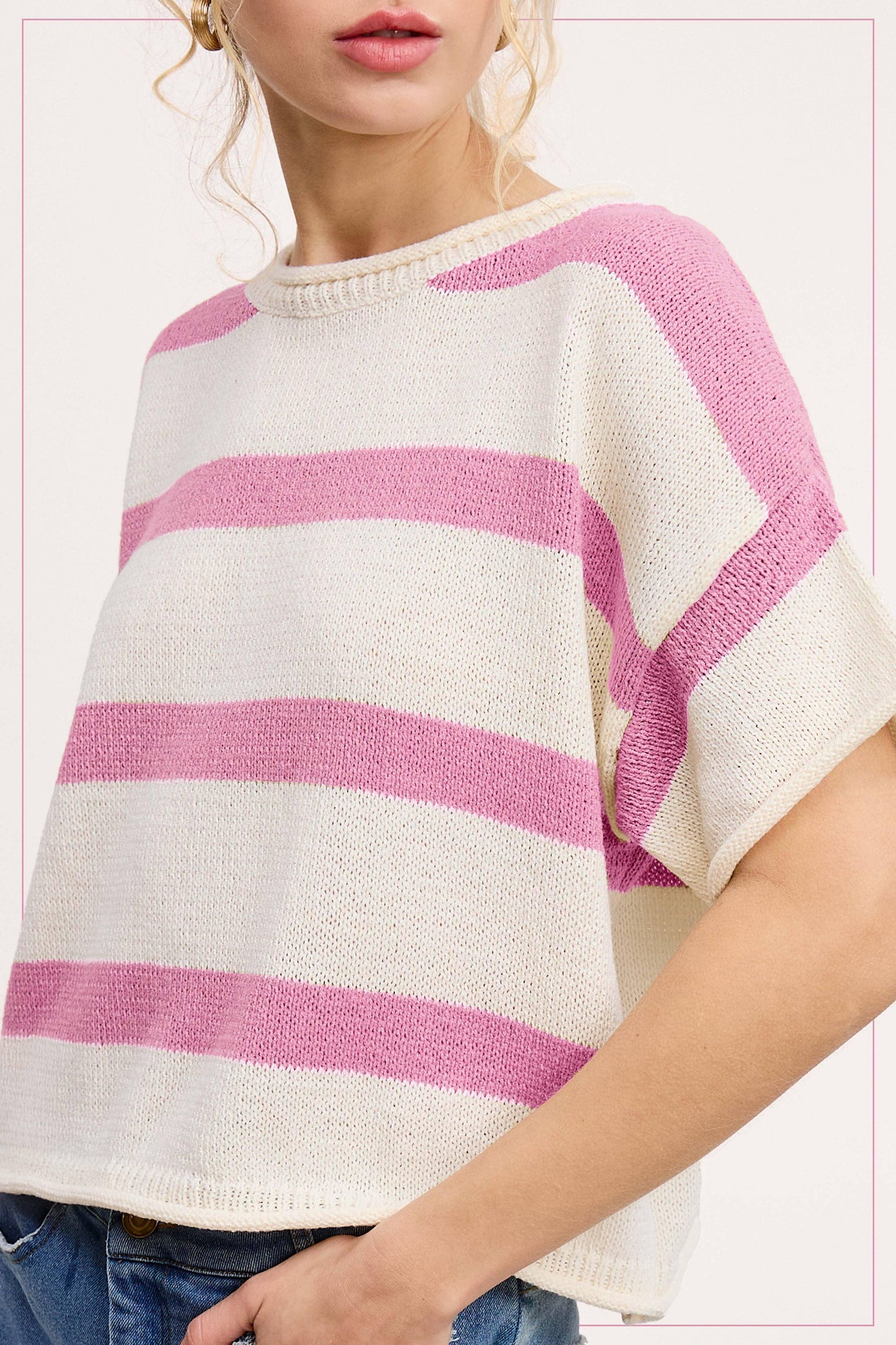 Woman wearing a short sleeve white and pink striped knit sweater with crew neck