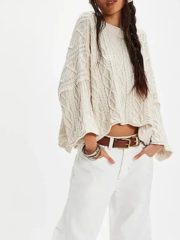 Woman wearing oversized cream cable knit sweater and white wide-leg pants