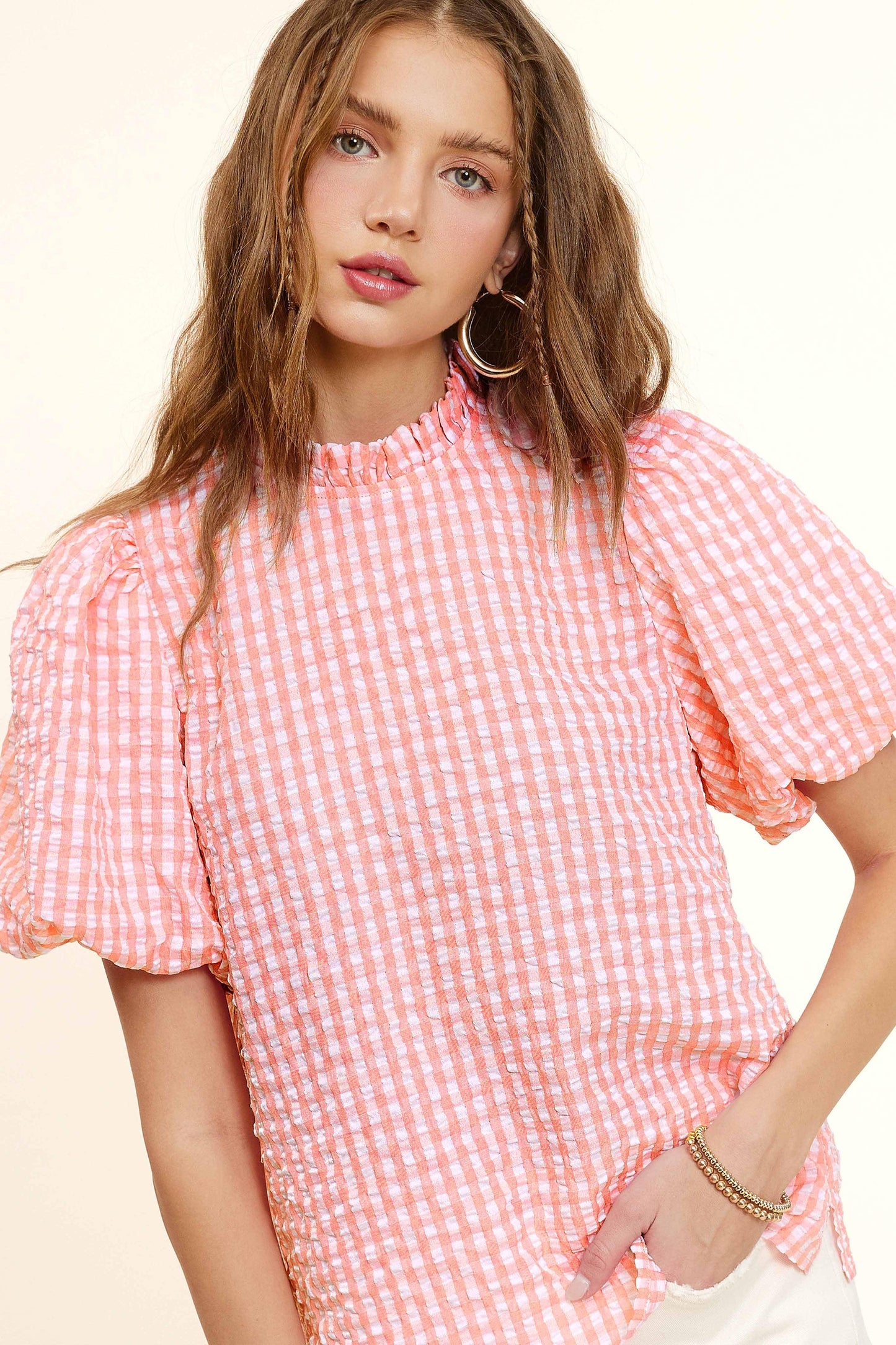 Woman in pink and white gingham blouse with puff sleeves, Lou's Boutique fashion