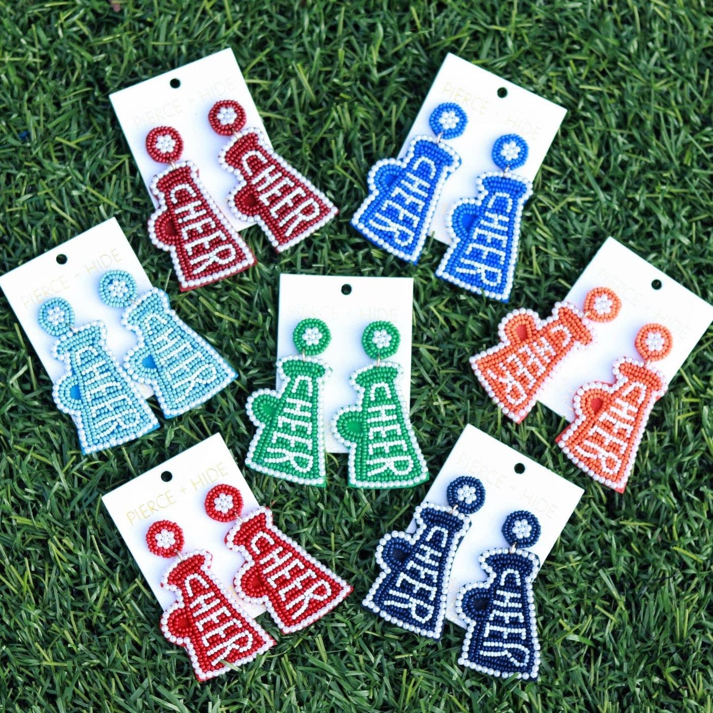 Beaded cheer megaphone earrings in assorted colors displayed on grass