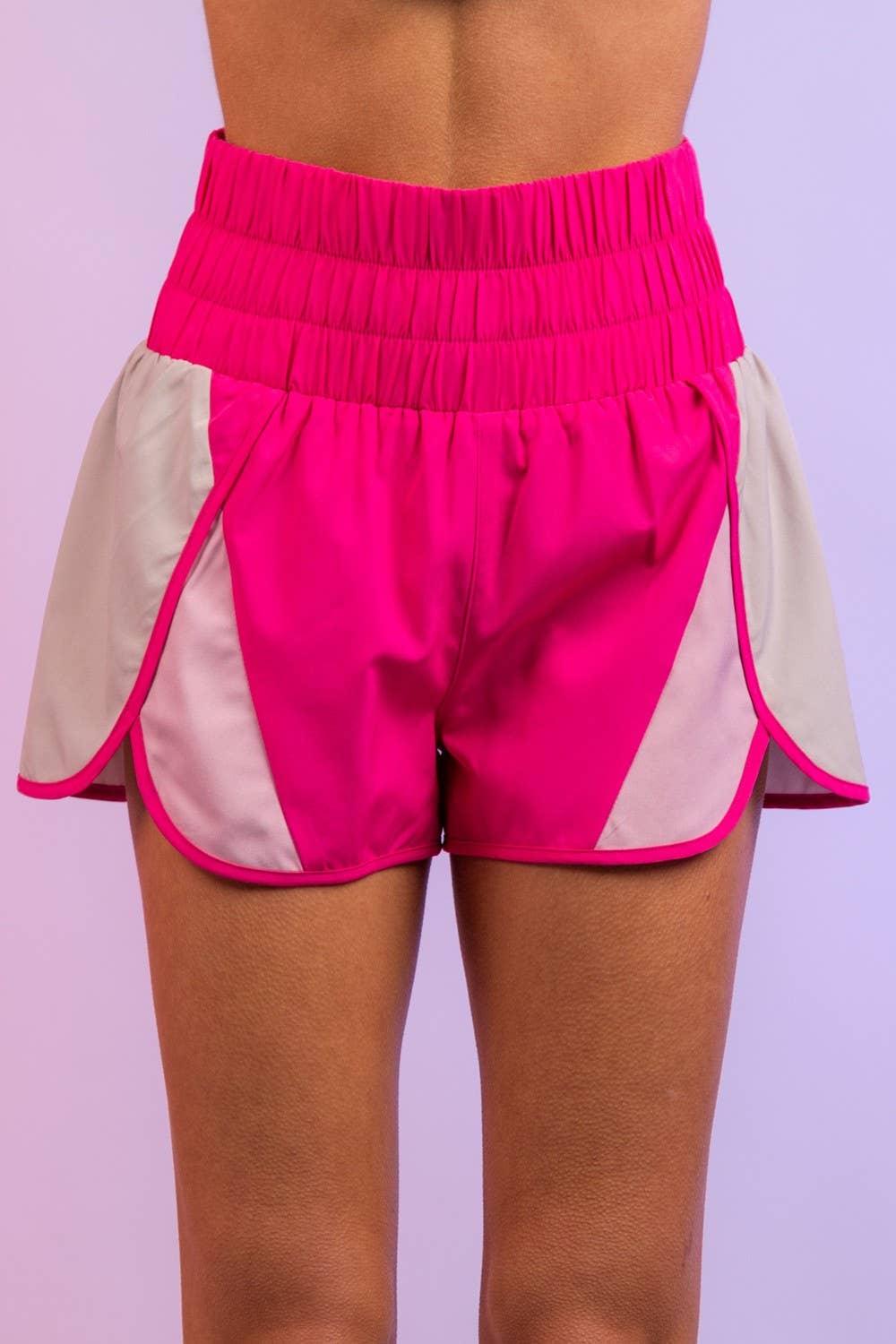Women's high waisted pink athletic shorts with white side panels