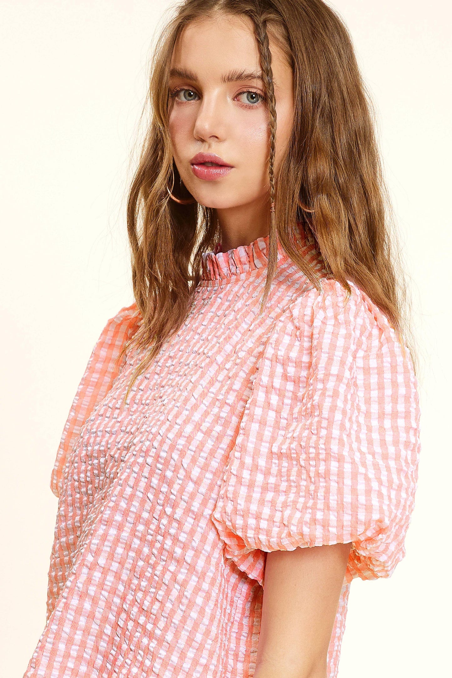 Woman modeling pink and white checkered puff sleeve blouse from Lou's Boutique