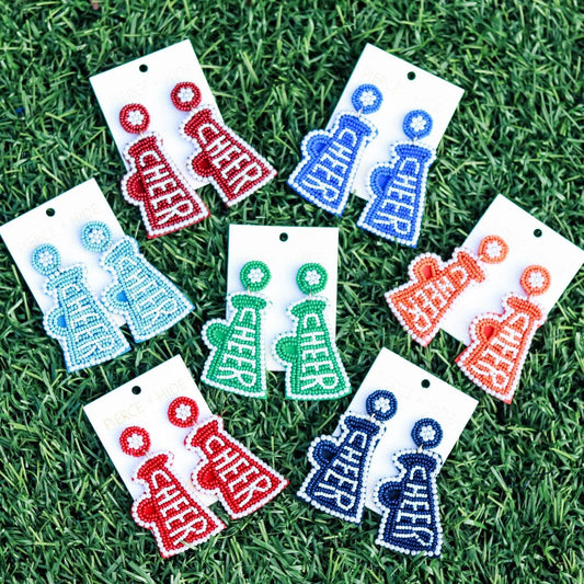 Colorful beaded cheer megaphone earrings displayed on grass, various team color options